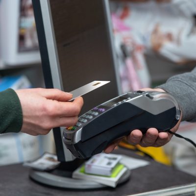 NFC technology, customer do payment with contactless credit card. Credit card reader implements payment execution, in the shop